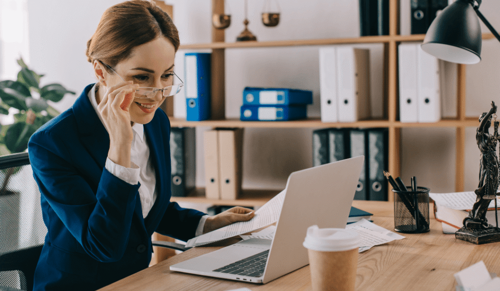 smiling female lawyer looking at laptop screen at HSCX97S 1 1080x628 1